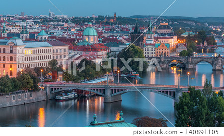 Aerial evening view of the Vltava River and illuminated bridges day to night timelapse, Prague Aerial evening view of the Vltava River and illuminated bridges day to night timelapse, Prague 140891105