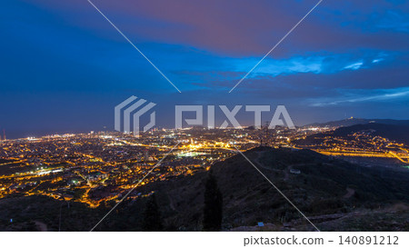 Barcelona and Badalona skyline with roofs of houses and sea on the horizon day to night timelapse Barcelona and Badalona skyline with roofs of houses and sea on the horizon day to night timelapse 140891212