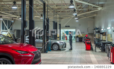 Cars moves on lifts in modern service station and men repair cars timelapse. Cars moves on lifts in modern service station and men repair cars timelapse. 140891229