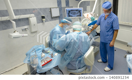 Dentists during surgery for implant placement timelapse. Dentists during surgery for implant placement timelapse. 140891234