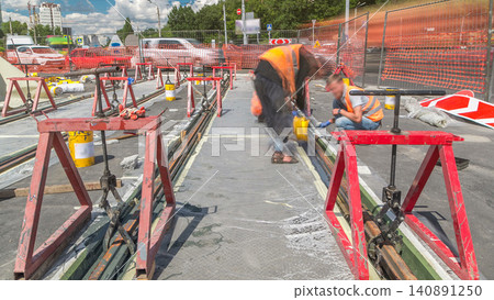 Tram rails at the stage of their installation and integration into concrete plates on the road timelapse Tram rails at the stage of their installation and integration into concrete plates on the road timelapse 140891250