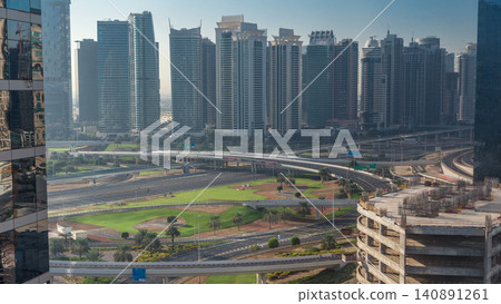 Aerial view to JLT and Dubai Marina with big highway intersection timelapse on sheikh zayed road and skyscrapers in the distance. Aerial view to JLT and Dubai Marina with big highway intersection timelapse on sheikh zayed road and skyscrapers in the distance. 140891261