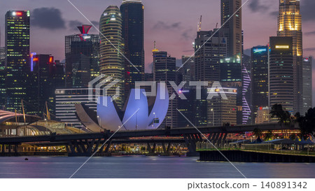 Downtown skyline of Singapore as viewed from across the water from The Garden East day to night timelapse. Singapore. Downtown skyline of Singapore as viewed from across the water from The Garden East day to night timelapse. Singapore. 140891342