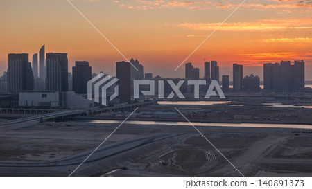 Buildings on Al Reem island in Abu Dhabi at sunset timelapse from above. Buildings on Al Reem island in Abu Dhabi at sunset timelapse from above. 140891373