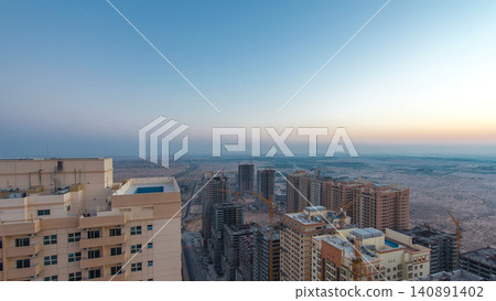 Cityscape of Ajman from rooftop night to day timelapse. Ajman is the capital of the emirate of Ajman in the United Arab Emirates. 140891402