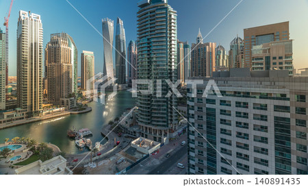 Aerial view of Dubai Marina residential and office skyscrapers with waterfront timelapse Aerial view of Dubai Marina residential and office skyscrapers with waterfront timelapse 140891435