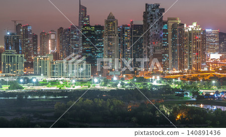 Jumeirah lake towers skyscrapers and golf course day to night timelapse, Dubai, United Arab Emirates Jumeirah lake towers skyscrapers and golf course day to night timelapse, Dubai, United Arab Emirates 140891436
