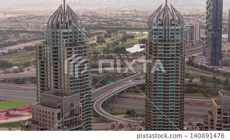 Dubai Marina skyscrapers and jumeirah lake towers sunrise view from the top aerial timelapse in the United Arab Emirates. Dubai Marina skyscrapers and jumeirah lake towers sunrise view from the top aerial timelapse in the United Arab Emirates. 140891476