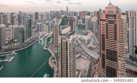 Dubai Marina skyscrapers and jumeirah lake towers view from the top aerial night to day timelapse in the United Arab Emirates. Dubai Marina skyscrapers and jumeirah lake towers view from the top aerial night to day timelapse in the United Arab Emirates. 140891481