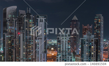 Modern residential and office complex with many towers aerial night timelapse at Business Bay, Dubai, UAE. Modern residential and office complex with many towers aerial night timelapse at Business Bay, Dubai, UAE. 140891504