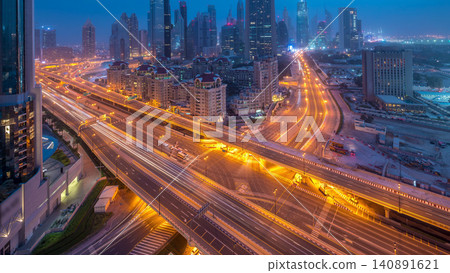 Dubai downtown skyline night to day aerial timelapse with traffic on highway Dubai downtown skyline night to day aerial timelapse with traffic on highway 140891621