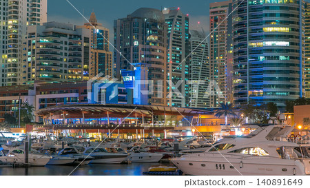 Dubai Marina towers and yachts reflected in water of canal in Dubai day to night timelapse Dubai Marina towers and yachts reflected in water of canal in Dubai day to night timelapse 140891649