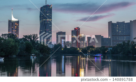 Vienna international center skyscrapers with Kaiserwasser lake reflection view day to night timelapse Vienna international center skyscrapers with Kaiserwasser lake reflection view day to night timelapse 140891788