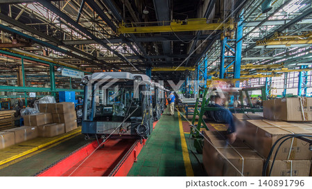 Conveyor assembly stage the body of tractor at big industrial factory timelapse Conveyor assembly stage the body of tractor at big industrial factory timelapse 140891796