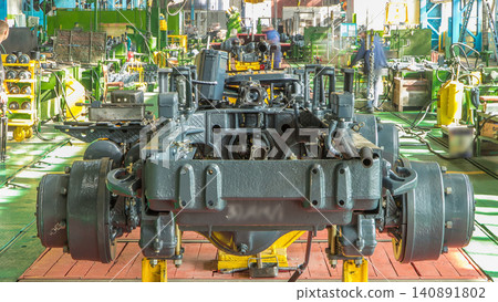 Conveyor assembly stage the body of tractor at big industrial factory timelapse Conveyor assembly stage the body of tractor at big industrial factory timelapse 140891802