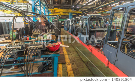 Conveyor assembly stage the body of tractor at big industrial factory timelapse 140891804