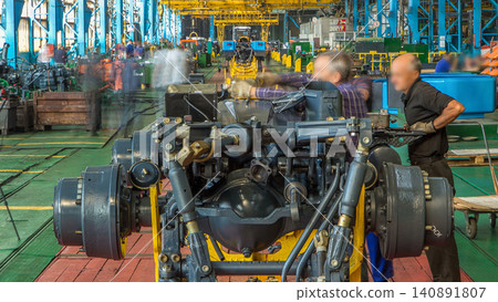 Conveyor assembly stage the body of tractor at big industrial factory timelapse Conveyor assembly stage the body of tractor at big industrial factory timelapse 140891807