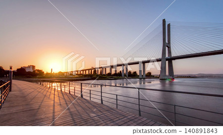 Vasco da Gama bridge during sunset and ebb-tide in Lisbon, Portugal. Timelapse 140891843