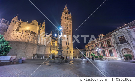 La Giralda and Seville Cathedral timelapse hyperlapse glowing under the night sky. La Giralda and Seville Cathedral timelapse hyperlapse glowing under the night sky. 140891902