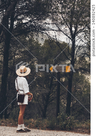 Traveler in forest with signpost: adventure and discovery in nature Traveler in forest with signpost: adventure and discovery in nature 140892425