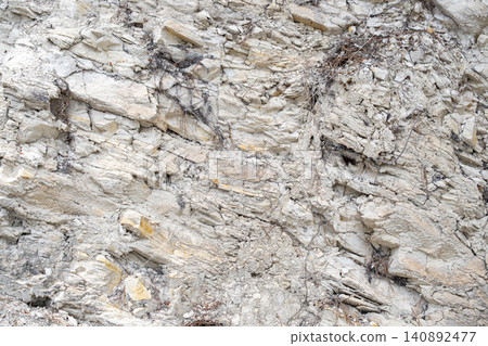 Natural rock formation with visible strata and weathered textures 140892477