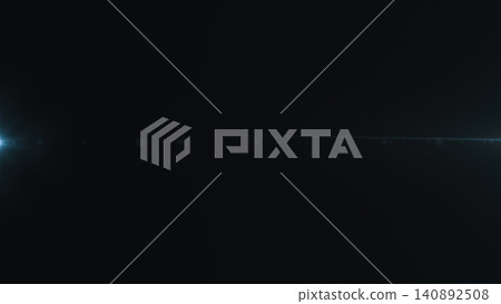 Abstract lens flare with light streak in dark background Abstract lens flare with light streak in dark background 140892508