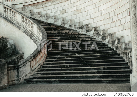 Historic stone staircase with elegant curved design in urban setting Historic stone staircase with elegant curved design in urban setting 140892766