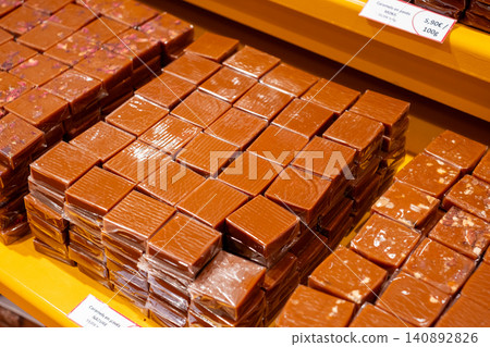 Delicious assortment of wrapped caramel cubes in a confectionery display Delicious assortment of wrapped caramel cubes in a confectionery display 140892826