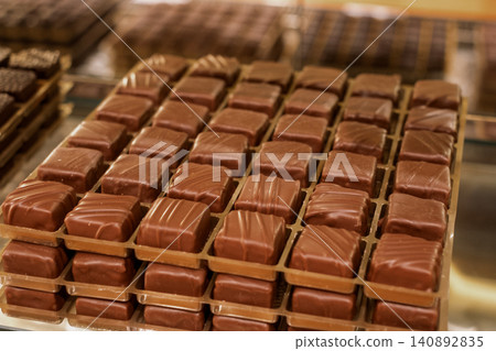 Delicious assortment of milk chocolate cubes on display in a sweet shop Delicious assortment of milk chocolate cubes on display in a sweet shop 140892835