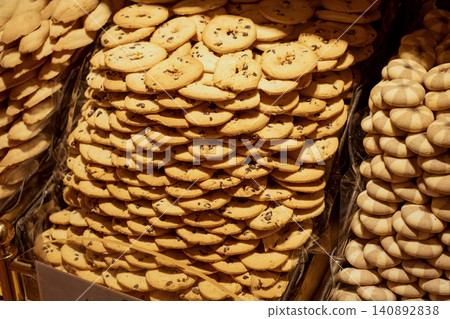 Delicious pile of assorted cookies displayed in a bakery setting Delicious pile of assorted cookies displayed in a bakery setting 140892838