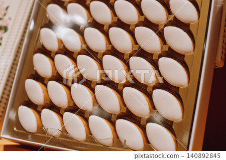 Elegant display of assorted macarons in a golden box for festive celebrations Elegant display of assorted macarons in a golden box for festive celebrations 140892845