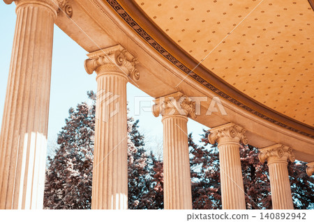 Majestic classical columns under golden ceiling with blue sky background Majestic classical columns under golden ceiling with blue sky background 140892942