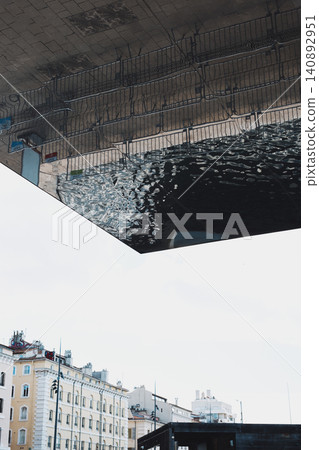Urban reflection abstract: city architecture mirrored in modern building 140892951