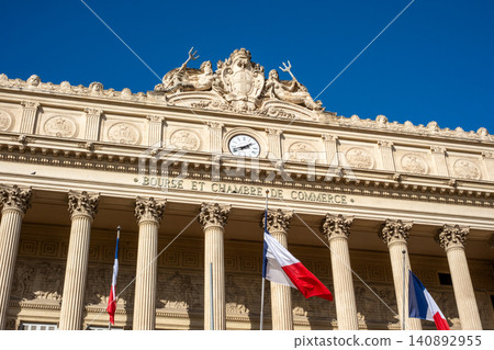 Historic facade of the parisian chamber of commerce with french flags and architectural details Historic facade of the parisian chamber of commerce with french flags and architectural details 140892955