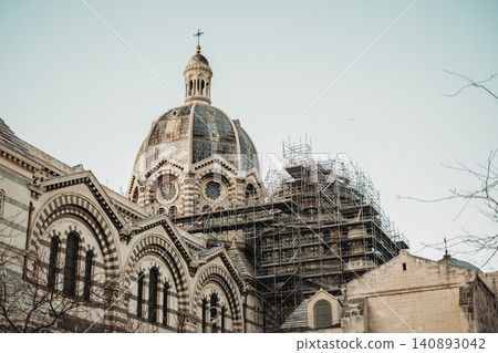Historic cathedral dome under restoration with scaffolding enhancing architectural details Historic cathedral dome under restoration with scaffolding enhancing architectural details 140893042