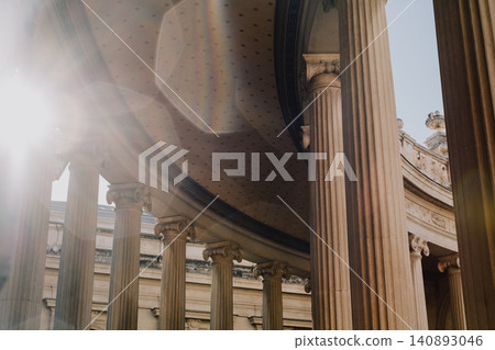 Sunlit classical architecture with majestic columns and lens flare Sunlit classical architecture with majestic columns and lens flare 140893046