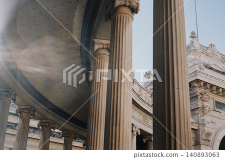 Majestic architectural columns with sunlight streaming through historic structure Majestic architectural columns with sunlight streaming through historic structure 140893063