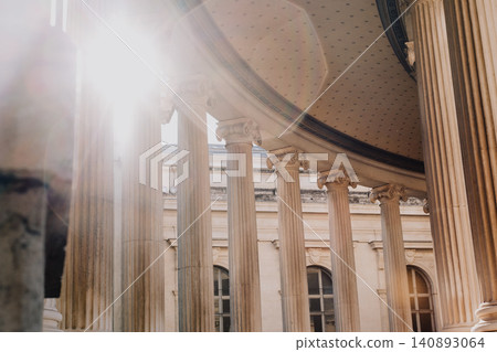 Sunlight streaming through classical columns of historic building Sunlight streaming through classical columns of historic building 140893064