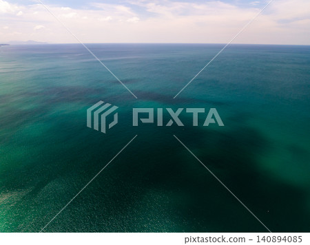Aerial view of sea surface water texture background,sun reflections Aerial flying drone view Waves water surface texture in sunny day Aerial view of sea surface water texture background,sun reflections Aerial flying drone view Waves water surface texture in sunny day 140894085