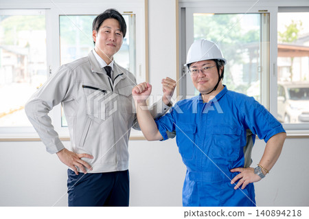 On-site staff demonstrating their cooperation in work clothes On-site staff demonstrating their cooperation in work clothes 140894218