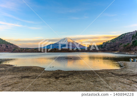 A spectacular view of Mount Fuji and the "Child-Holding Fuji" at sunset from Lake Shoji. A spectacular view of Mount Fuji and the "Child-Holding Fuji" at sunset from Lake Shoji. 140894228