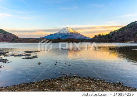 A spectacular view of Mount Fuji and the "Child-Holding Fuji" at sunset from Lake Shoji. A spectacular view of Mount Fuji and the "Child-Holding Fuji" at sunset from Lake Shoji. 140894229