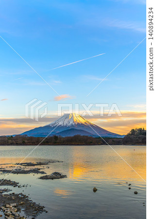 A spectacular view of Mount Fuji and the "Child-Holding Fuji" at sunset from Lake Shoji. A spectacular view of Mount Fuji and the "Child-Holding Fuji" at sunset from Lake Shoji. 140894234