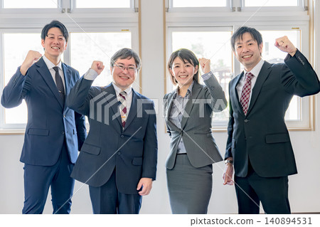Business team doing a guts pose Business team doing a guts pose 140894531