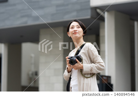 A woman with a camera A woman with a camera 140894546