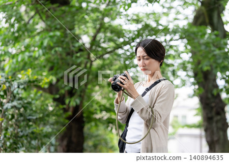 A woman with a camera A woman with a camera 140894635