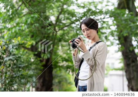 A woman with a camera A woman with a camera 140894636