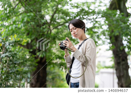 A woman with a camera A woman with a camera 140894637