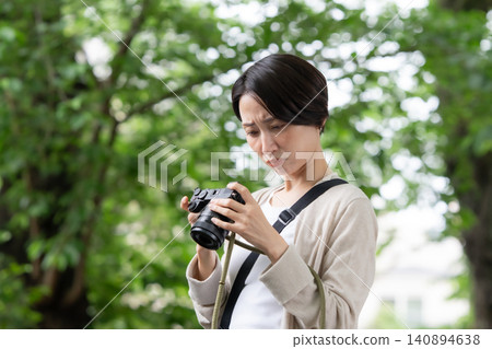 A woman with a camera A woman with a camera 140894638