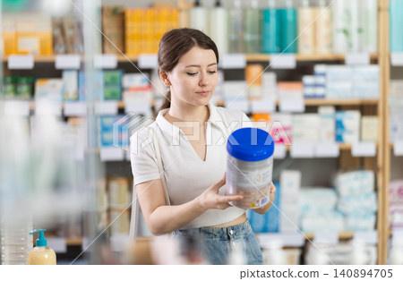 Woman buys food for small children in supermarket Woman buys food for small children in supermarket 140894705